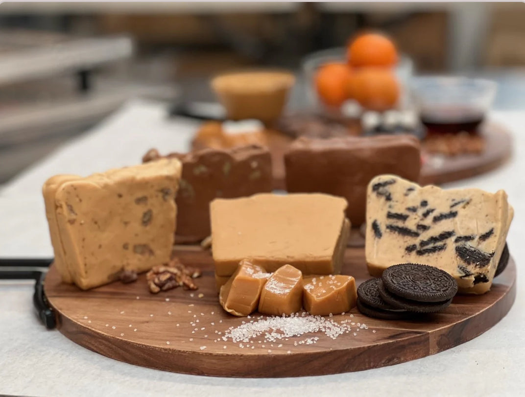 An assortment of handcrafted Spectrum Fudge flavors on a wooden serving board.